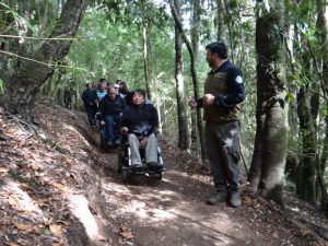 Trilha acessível inaugurada no Chile com pessoas em cadeiras de rodas passando por ela.